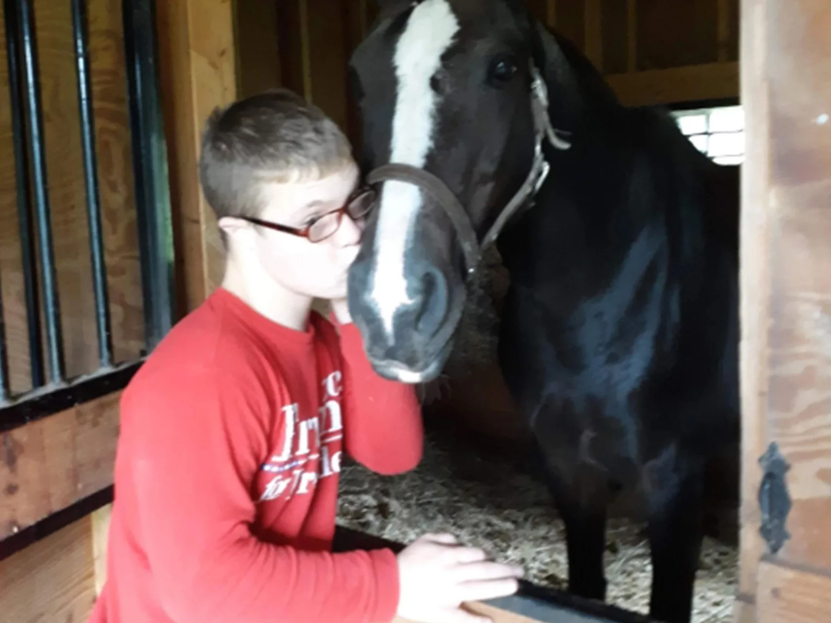 Thomas Grenier kisses the nose of a horse